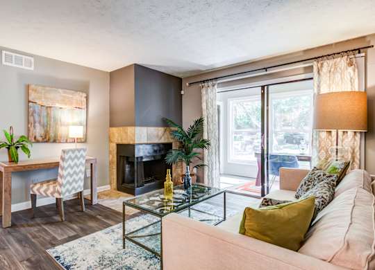 Pet Friendly Apartments in Roswell, GA - 2200 Big Creek Apartments - living room with fireplace and large windows