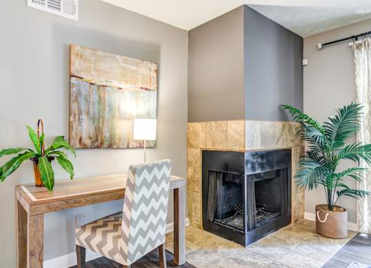 Pet Friendly Apartments in Roswell, GA - 2200 Big Creek Apartments - living room area with fireplace and desk