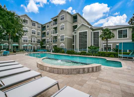 Townhomes for Rent in Houston, TX - The Maroneal - Resort Style Pool with Hot Tub, Lounge Seating, Palm Trees, and Greenery