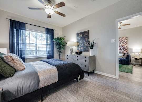 a bedroom with a bed and a ceiling fan