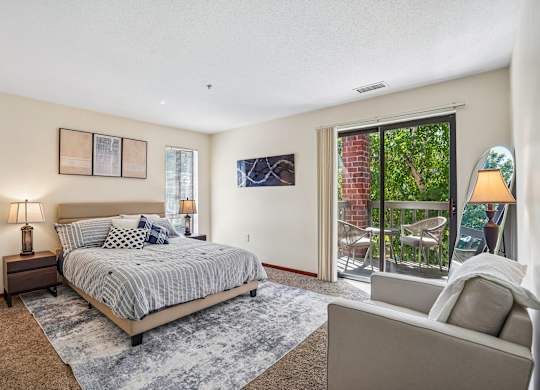 A bedroom with a large bed and a couch.