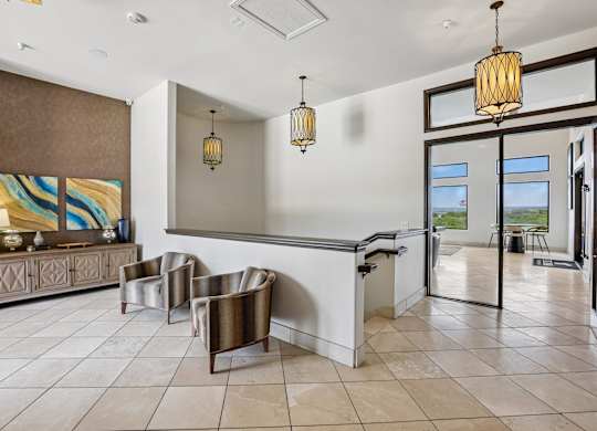 A room with a brown and white color scheme and a large painting on the wall.