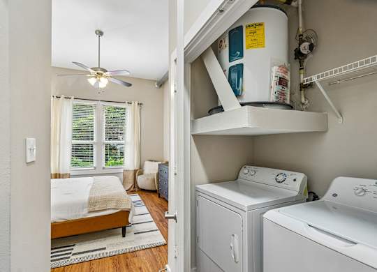 A white laundry room with a washer and dryer.