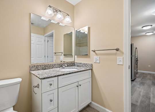 A bathroom with a white tub and sink vanity.