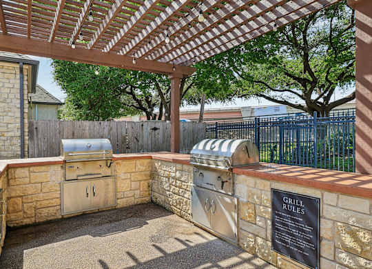A grill area with a grill rules sign.