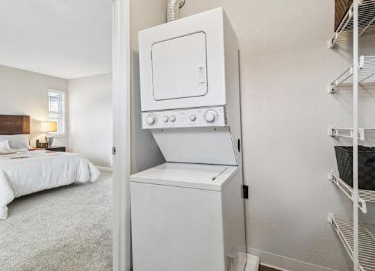 A white oven is in a kitchen next to a bedroom.