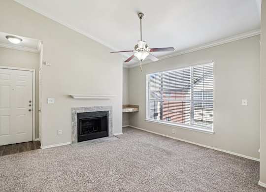A room with a fireplace and a ceiling fan.