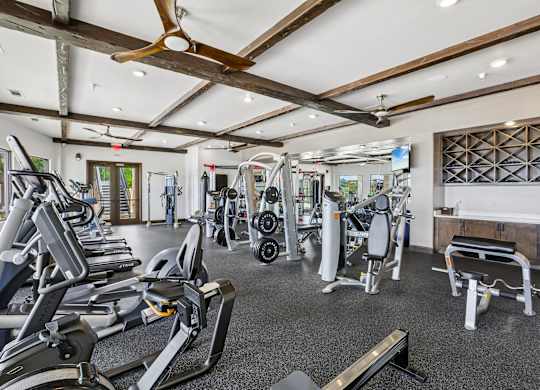 A gym with treadmills, weights, and other exercise equipment.