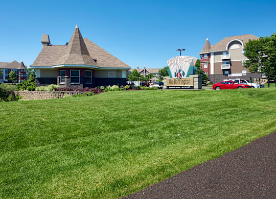 a large lawn in front of a house with a sign for a movie theater