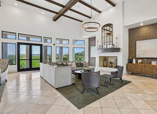 A modern living room with a large sofa set and a fireplace.