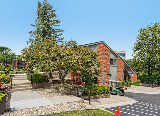 A red brick building with a green lawn in front.