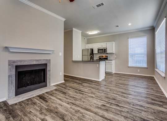 Apartments in Plano, TX - Modern Living Room with Hardwood Flooring and Access to Kitchen