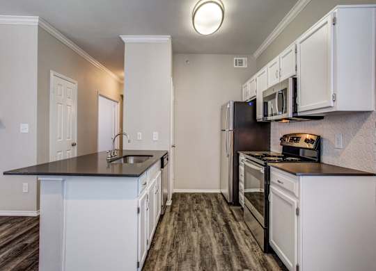 Luxury Apartments in Plano TX - Carrington Park - Modern Kitchen with White Cabinets and Stainless Steel Appliances