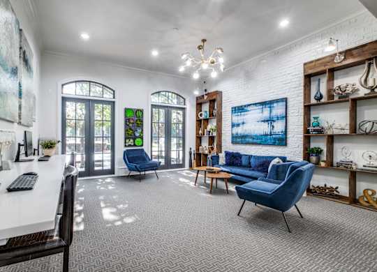 A room with a white desk and a blue chair.