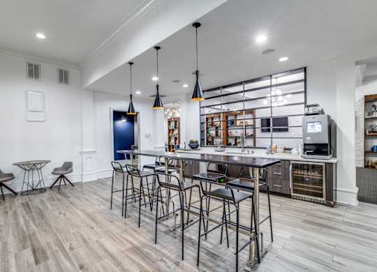 A modern kitchen with a bar area and a television.