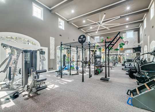 A gym with a variety of equipment including weights and machines.