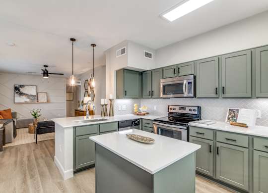 A modern kitchen with a large island in the center.