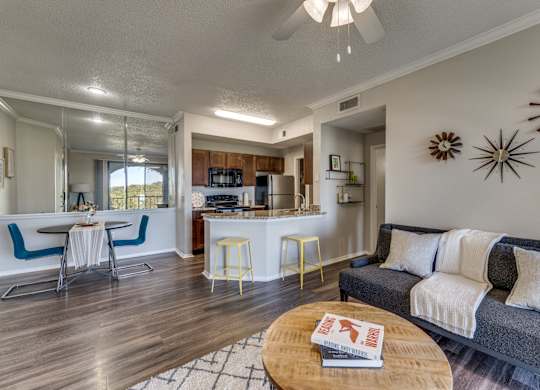 a living room and kitchen with a couch and a table