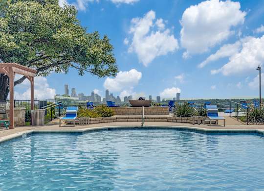 a pool with a view of the city in the background