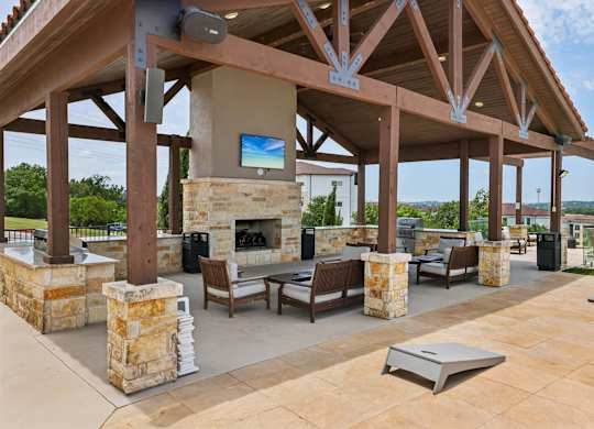 A patio with a fireplace and seating area.