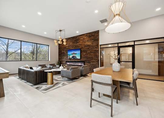 the living room and dining room in a modern home with a tv on the wall