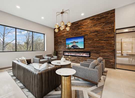 a living room with couches and chairs and a fireplace