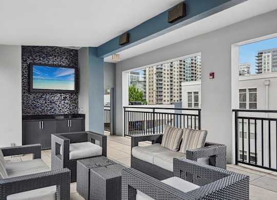 A balcony with a black railing and a white couch.