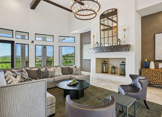 A living room with a fireplace and a large window.
