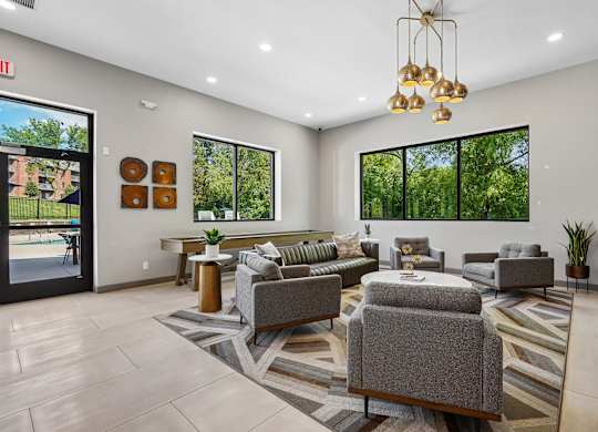 A spacious waiting room with grey couches and a striped rug.