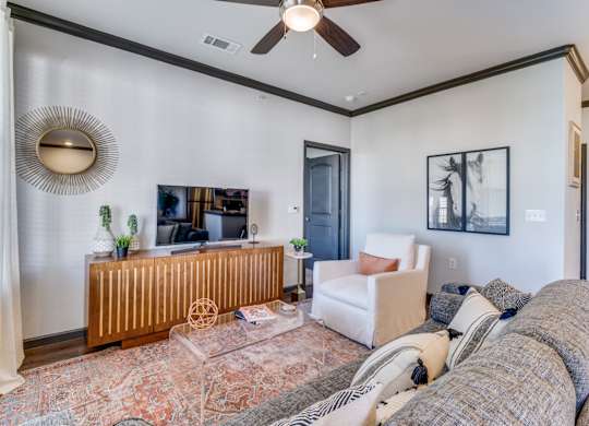 a living room with a couch and a ceiling fan