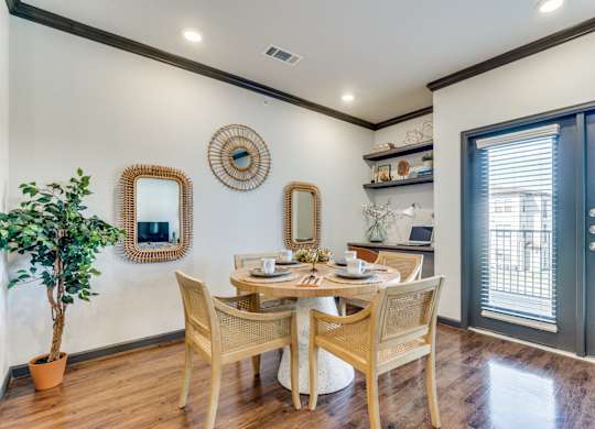 a dining room with a table and chairs and a window