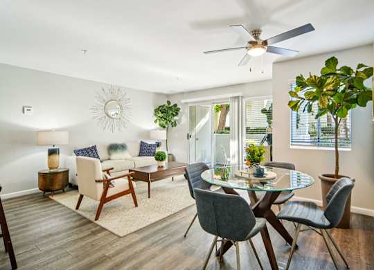 A modern dining room with a glass table and chairs.