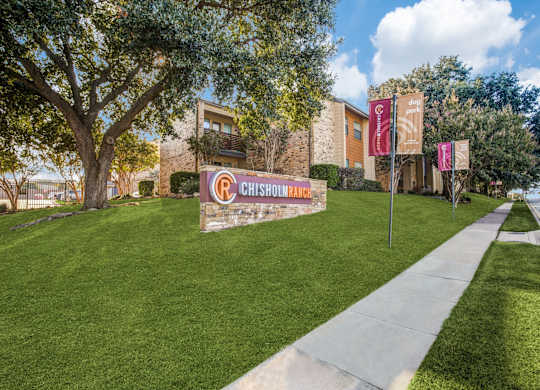 A Chisholm sign is displayed in front of a building.