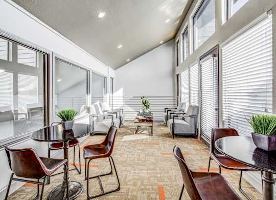 A modern dining room with a glass table and chairs.