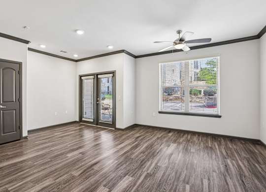 A room with a wood floor and a ceiling fan.