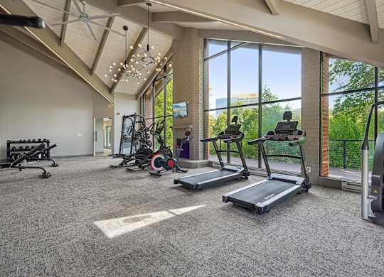 A spacious gym with treadmills, elliptical machines, and other exercise equipment.