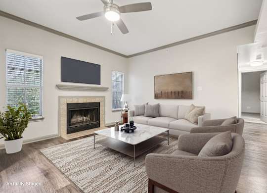 A living room with a fireplace and a television.