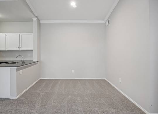 A kitchen with white cabinets and a countertop.
