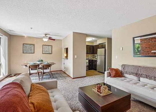 A living room with a white couch and a coffee table.