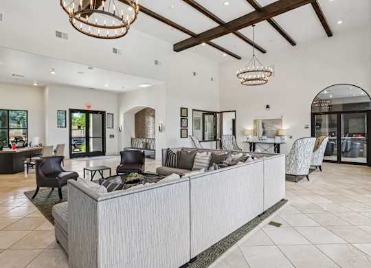 A spacious living room with a reception desk and chairs.