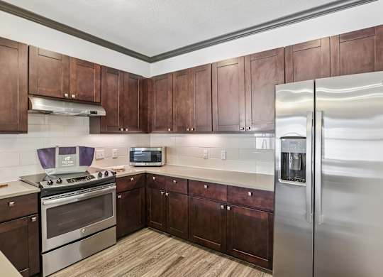 A kitchen with wooden cabinets and stainless steel appliances.