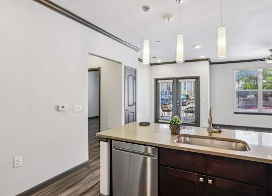 A modern kitchen with a stainless steel dishwasher and a sink.