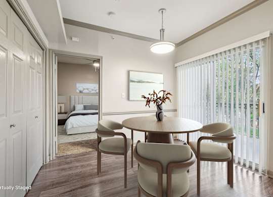 A dining room with a round table and chairs.