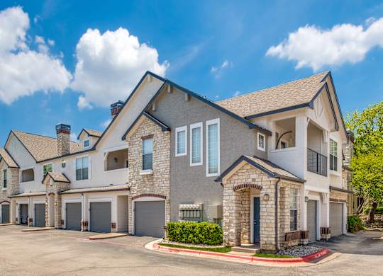 external view of a house with a driveway and garage doors