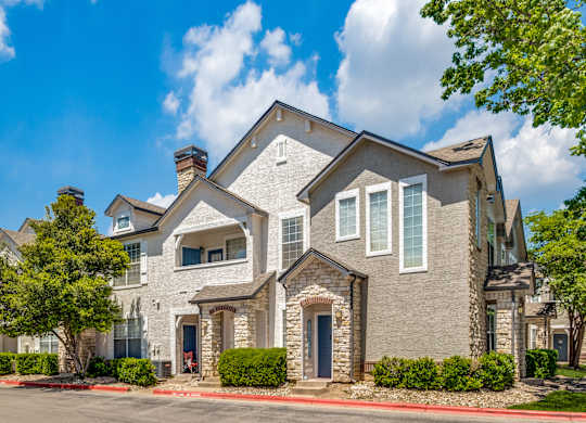 the view of a house with a street in front of it