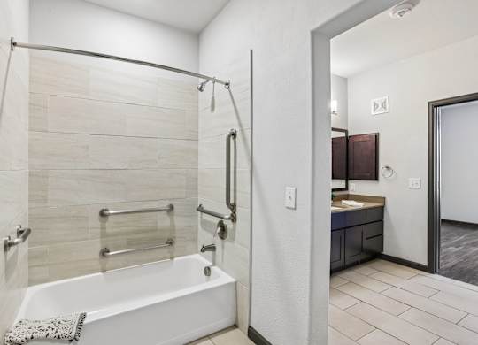 A white bathroom with a walk-in shower and a white bathtub.