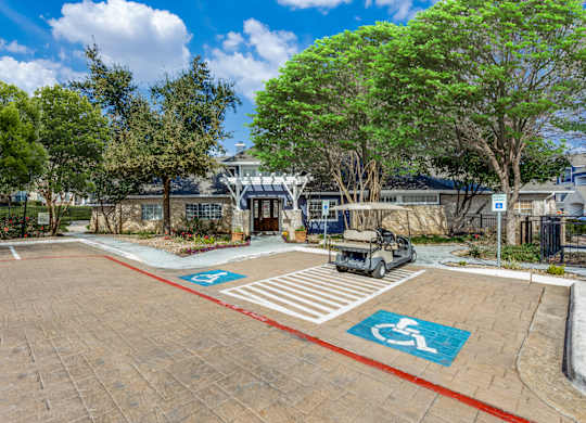 A parking lot with a car and a golf cart parked in the disabled parking spaces.