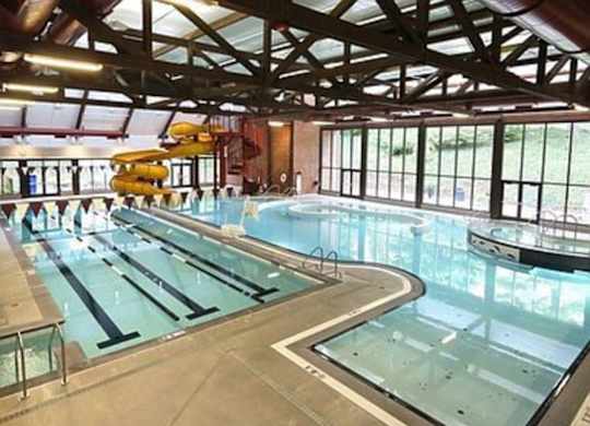 Pet-Friendly Apartments in Mountain Park, OR - MiLO at Mountain Park - Indoor Pool with Waterslide, Jacuzzi, and Floor-to-Ceiling Windows