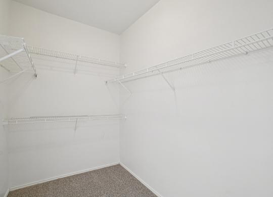 A white room with two shelves.