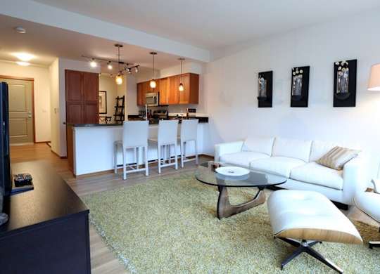 A living room with a white couch and a coffee table.